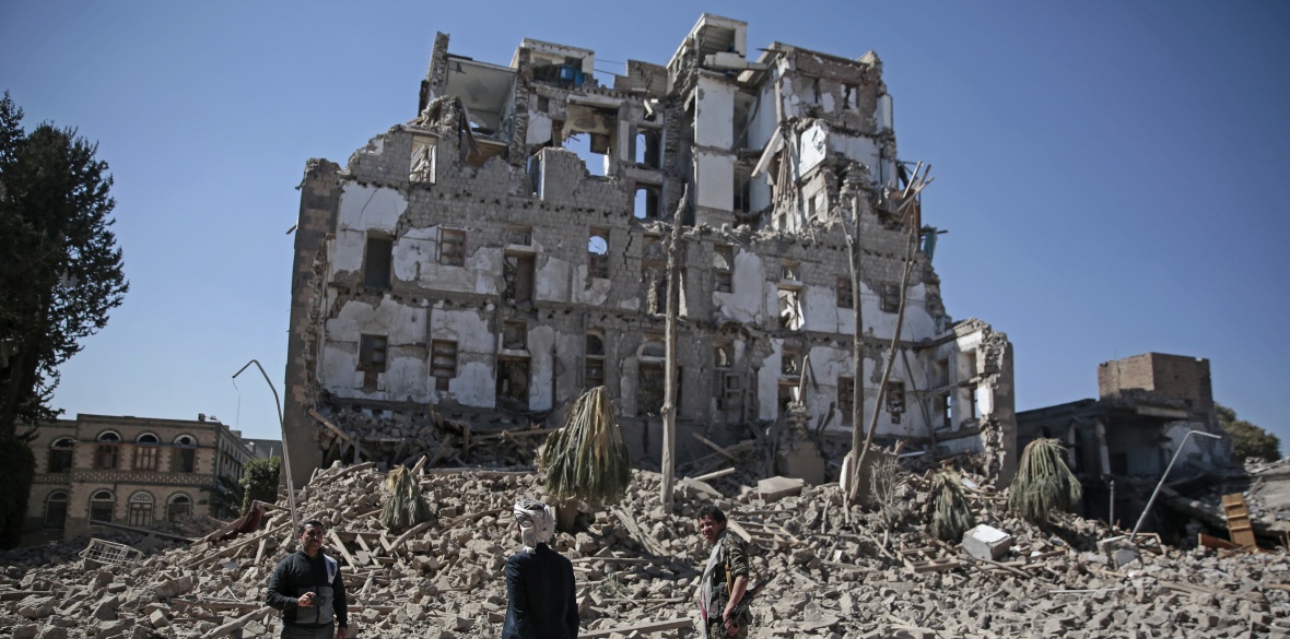 A Houthi fighter walks amid the rubble of the Republican Palace that was destroyed by Saudi-led airstrikes, in Sanaa, Yemen, on Wednesday December 6 2017
