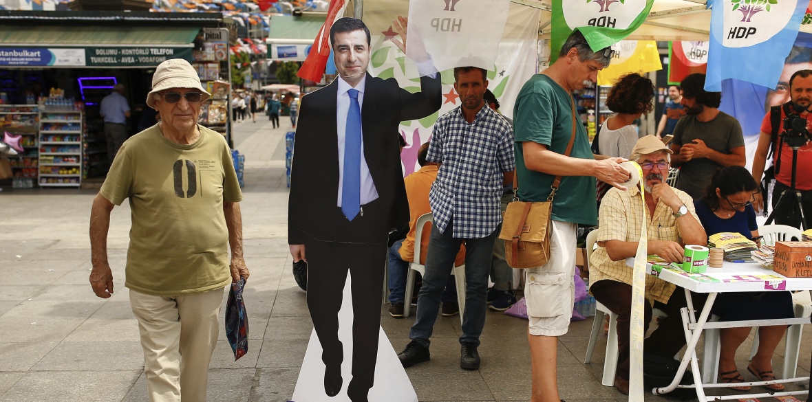 A cardboard cutout of HDP presidential candidate Selahattin Demirtas stands near a party election stall in Istanbul