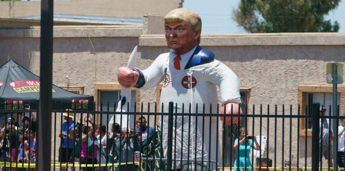 Protesters place a large inflatable balloon in the likeness of President Donald Trump dressed in a Ku Klux Klan sheet across the street from Southwest Key Campbell, a shelter for children that have been separated from their parents, in Phoenix, Arizona, last week