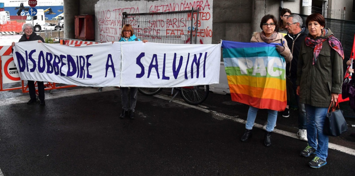 Italian activists hold up a banner which says ‘Disobey Salvini’ as they protest against the Saudi Arabian freighter Bahri Yanbu docked in Genoa's port