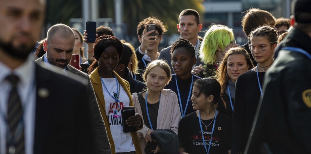 Climate activist Greta Thunberg (centre) walks at the COP25 climate talks summit in Madrid