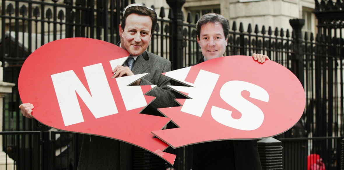Two actors wearing Nick Clegg (right) and David Cameron masks break a heart, with the words NHS printed on it, during a protest by Unison union members against the Health and Social Care Bill, at the gates of Downing Street in London in February 2012