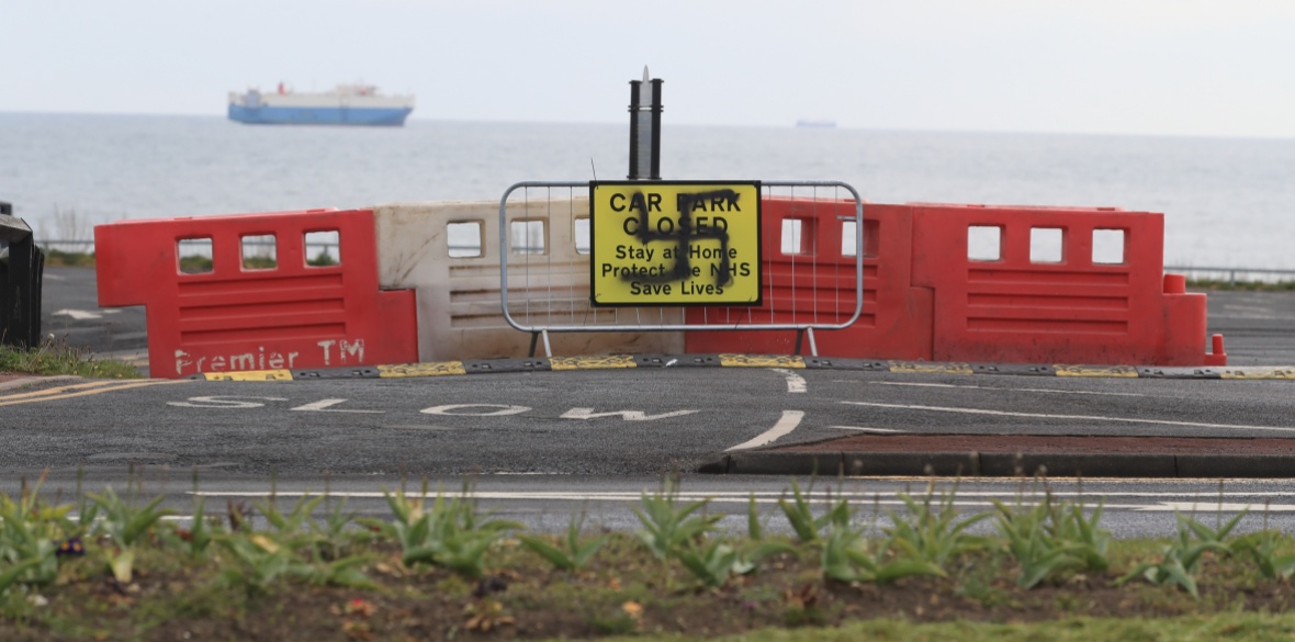 A swastika spray-painted on a sign informing the public that car park is closed near the beach at the Briar Dene car park in Whitley Bay, Northumberland