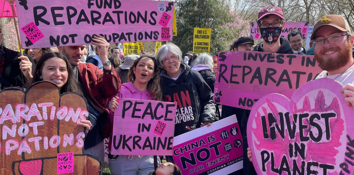 A protester holding a placard saying U.S. war machine: real threat to  peace at a rally against war with Russia sponsored by multiple groups  including CODEPINK: Women for Peace, Black Alliance for