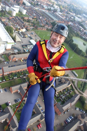 John gets set to abseil down the enormous tower