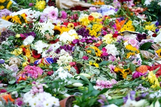 Piles of flowers laid in London’s Green Park in tribute to the late queen