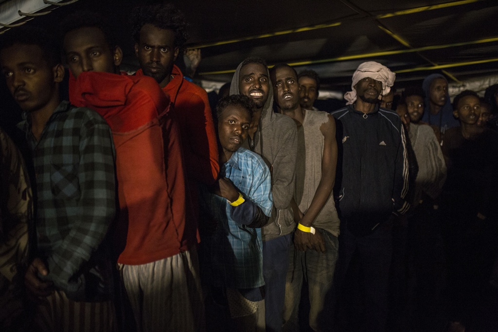 Migrants on the deck of the Spanish NGO Proactiva Open Arms rescue vessel, after being rescued in the Central Mediterranean Sea