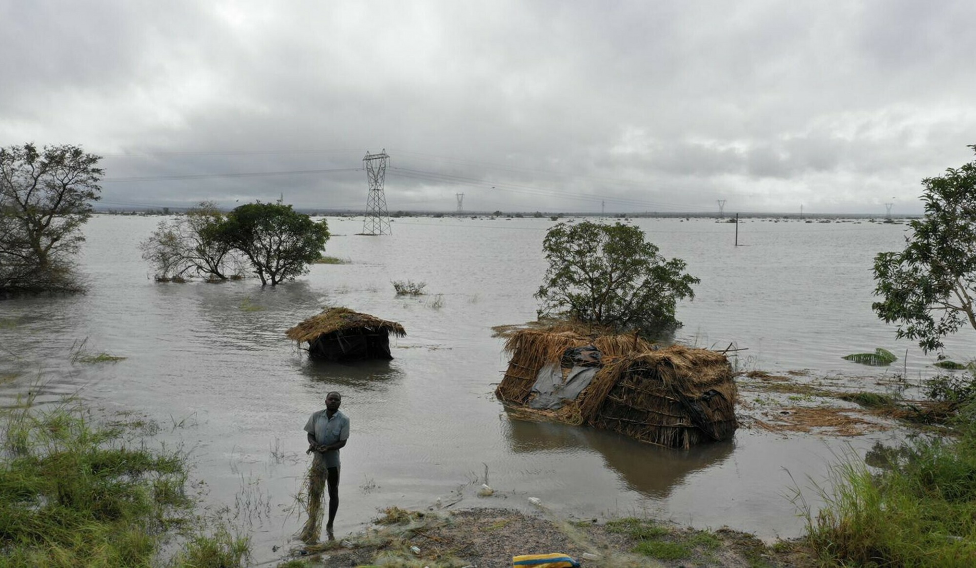 A man stands in flood waters following cyclone force winds and heavy rain near the coastal city of Beira, Mozambique, Wednesday March 20