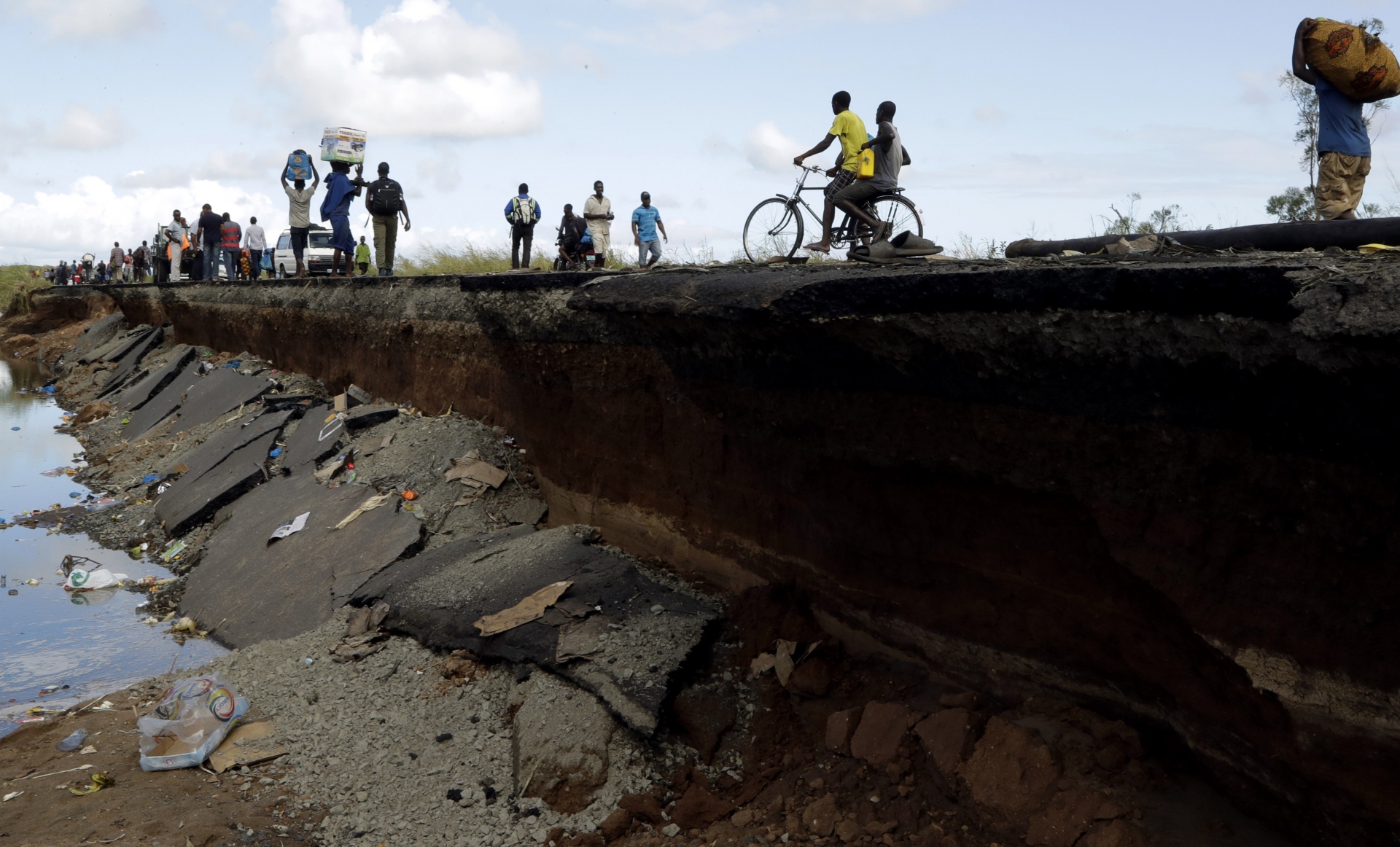 Pedestrians walk on the edge of a collapsed bridge in Nhamatanda, about 100km west of Beira, yesterday