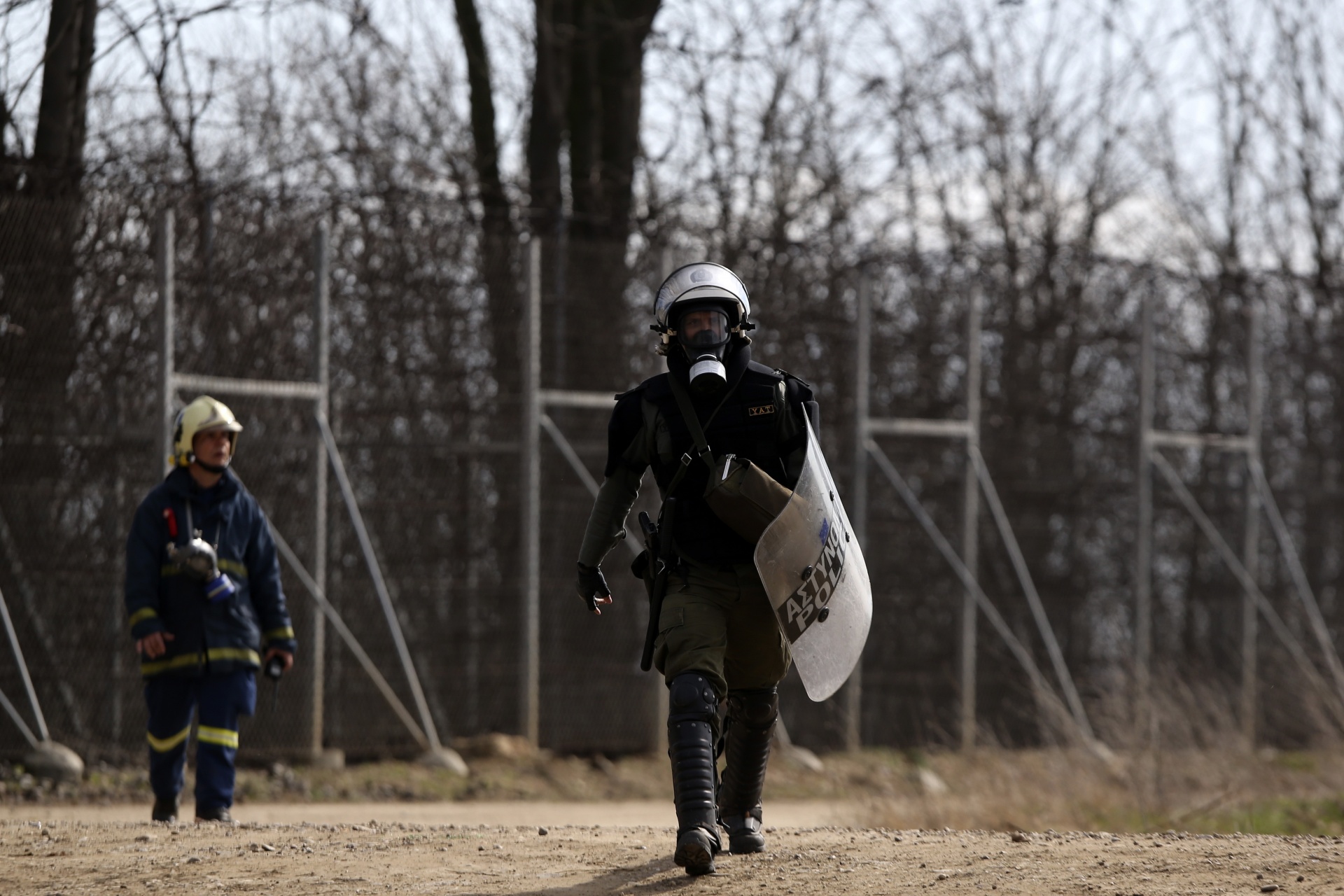 A Greek riot policeman walks near the Kastanies border gate at the Greek-Turkish border