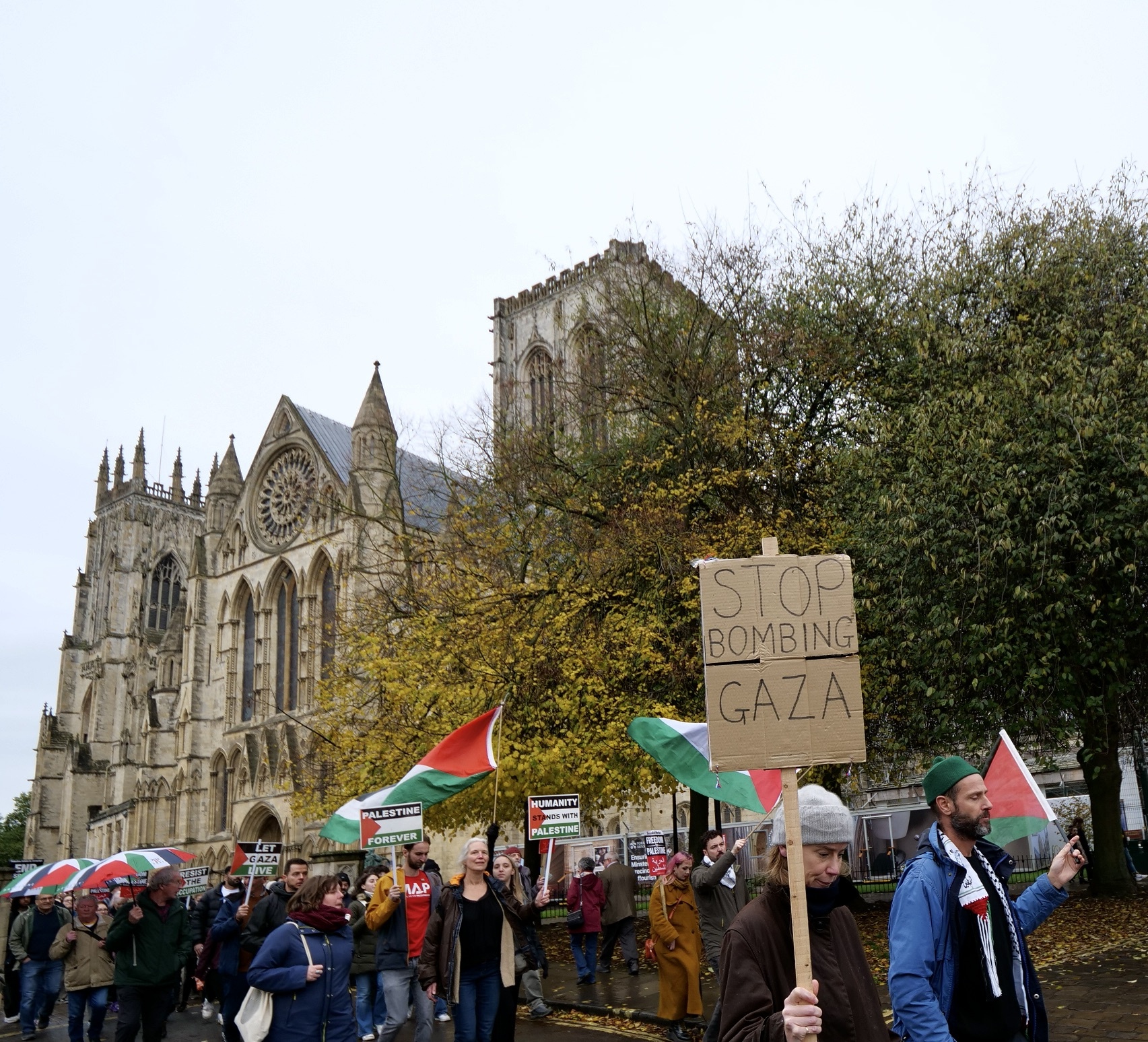 Protesters march past the iconic York Minster