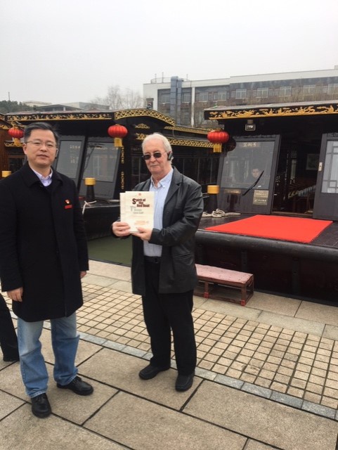 Communist Party of Britain General Secretary and delegation leader Robert Griffiths being presented with gifts by the Curator of the Nanhu Revolutionary Memorial Museum