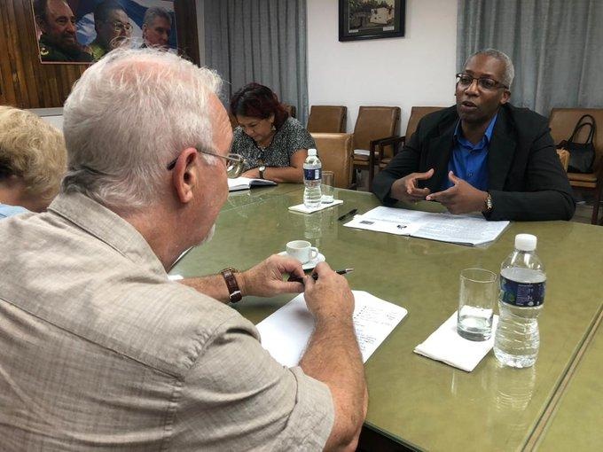 Robert Griffiths (left) listens to Joel Queipo Ruiz, head of the Cuban Communist Party’s economic department 