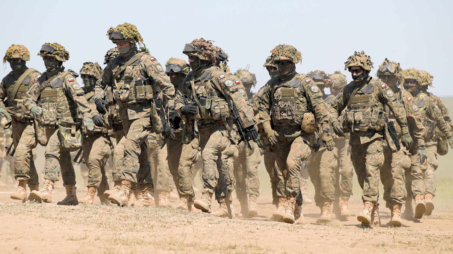 Polish troops march after the Justice Sword 21 exercise at the Smardan military shooting range, Romania, May 11, 2021. Justice Sword was part of Defender Europe 21, a large-scale US Army-led, multinational, joint exercise designed to build 'readiness and interoperability' between the US, NATO and partner militaries. 