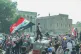 UPRISING: An Iraqi protester waving a Flag of Iraq during a 