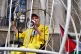 Vivienne Westwood is suspended in a bird cage outside the Ol