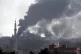 In a photo taken from the Turkish side of the border, smoke 