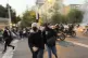Women run away from anti-riot police during a protest over t