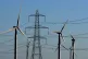 A view of the Little Cheyne Court Wind Farm amongst existing electricity pylons on the Romney Marsh in Kent