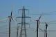 A view of the Little Cheyne Court Wind Farm amongst existing electricity pylons on the Romney Marsh in Kent
