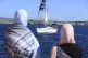 Supporters watch as a boat that is part of the Global Sumud Flotilla departs to Gaza to deliver aid amidst Israel's blockade on the Palestinian territory, in the Tunisian port of Bizerte, September 13, 2025