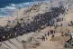 Displaced Palestinians walk along the coastal road near Wadi Gaza in the central Gaza Strip, moving toward northern Gaza, October 10, 2025