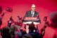 People wave flags as Prime Minister Sir Keir Starmer delivers his keynote speech during the Labour Party Conference at the ACC Liverpool, September 30, 2025