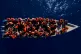 Migrants from Eritrea, Libya and Sudan sail a wooden boat before being assisted by aid workers of the Spanish NGO Open Arms, in the Mediterranean sea, about 30 miles north of Libya, June 17, 2023