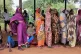 Women wait for cash assistance and dry grain from the UN World Food Programme in Gendrassa refugee camp, Maban, South Sudan, August 20, 2025