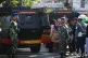 Curious onlookers look on as military personnel stand guard near a school where explosions reportedly occurred, in Jakarta, Indonesia, Friday, Nov. 7, 2025