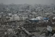 A destroyed Israeli armored vehicle sits amid widespread devastation in Gaza City, November 27, 2025