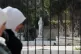 Syrian women walk past a fence of the National Museum of Syria in Damascus, Syria, November 12, 2025