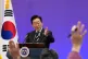 South Korean President Lee Jae Myung gestures during a news conference to mark the first anniversary of the December 3 martial law crisis at the Blue House in Seoul, South Korea
