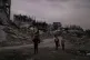 Palestinians walk on a street in Jabaliya, northern Gaza Strip, Saturday, Dec. 6, 2025
