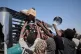 Sudanese families displaced from El-Fasher reach out as aid workers distribute food supplies at the newly established El-Afadh camp in Al Dabbah, November 16, 2025