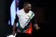 David Munyua reacts during his match against Mike De Decker on day eight of the Paddy Power World Darts Championship at the Alexandra Palace, London, December 18, 2025
