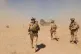 British soldiers walk to a military helicopter near the Pimon military camp in Nad-e Ali district of Helmand province, March 25, 2010