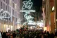 People walk through the Corso Vittorio Emanuele II main downtown street as Olympic Iconic neon hang for the upcoming Milan-Cortina Winter Olympics in Milan, Italy, December 27, 2025
