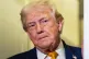 President Donald Trump listens as he was speaking with reporters while in flight on Air Force One, Sunday, Jan. 4, 2026, as returning to Joint Base Andrews, Md