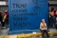Graffiti that reads in Spanish: ‘Trump: murderer, kidnapper, pedophile, damned,’ (left), and ‘Long live peace,’ covers a kiosk during a march to demand President Nicolas Maduro's return, in Caracas, Venezuela, January 6, 2026