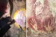 (L to R) Scientist Adhi Agus Oktaviana studies handprints on the walls of a cave in Sulawesi, Indonesia; Handprints with sharpened fingertips in the Maros region of Sulawesi, Indonesia / Pics: (L to R) Maxime Aubert via AP; Ahdi Agus Oktaviana/Maxime Aubert via AP