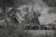 People gather in front of a destroyed building that was hit by an Israeli airstrike in Ain Qana village, south Lebanon, February 2, 2026