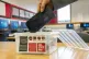 A student places a mobile phone in a box before the start of a lesson, August 15, 2024