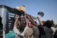 Sudanese families displaced from El-Fasher reach out as aid workers distribute food supplies at the newly established El-Afadh camp in Al Dabbah, Sudan's Northern State, November 16, 2025