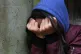 A teenage girl with her head in her hands showing signs of mental health issues (picture posed by a model)