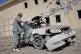 A man inspects a car damaged after a Pakistani strike in on a refugee camp in Takhta Pul district, Kandahar province, Afghanistan, February 28, 2026