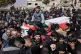 The son of a Lebanese soldier, cries as he sits on his father's coffin who was killed by Israeli airstrikes, during a funeral procession in Khraibeh village, eastern Lebanon, Sunday, March 8, 2026