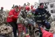 Rescue workers carry a severely injured man after pulling him from the rubble following a strike in southern Tehran, Iran, Friday, March 13, 2026