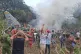 People stand around a military cargo plane that crashed after taking off from Puerto Leguizamo, Colombia, a remote municipality in the Amazonian province of Putumayo, March 23, 2026