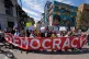 People march through the Country Club Plaza shopping district during a 